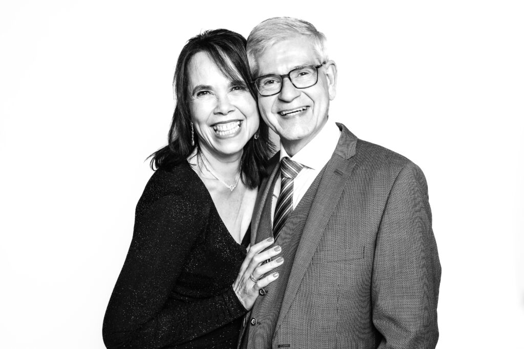 Gasten poseren samen voor photobooth met witte achtergrond op bruiloft